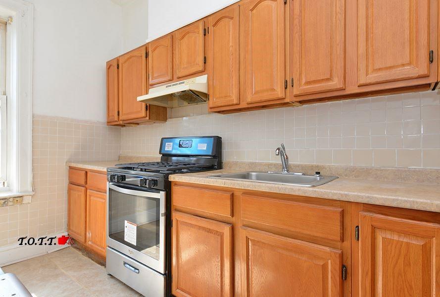 166 Martense Street Brooklyn, NY 11226 - Photo 6 of 14 a kitchen with stainless steel appliances granite countertop a sink stove and cabinets