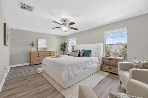 a bedroom with a bed and a large window