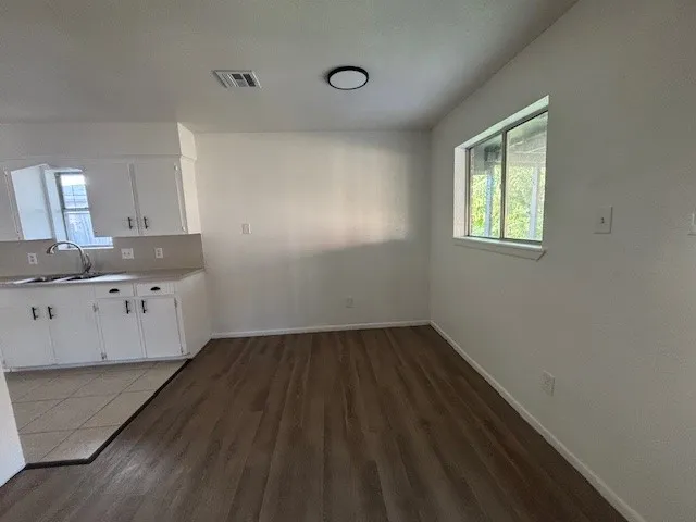 a room with a window and wooden floor