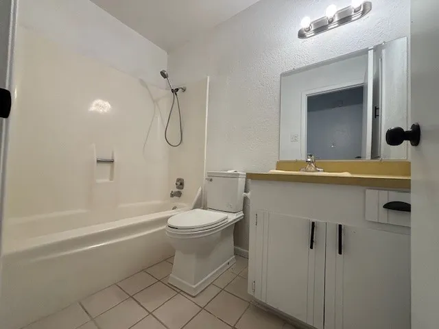 a bathroom with a toilet sink and shower