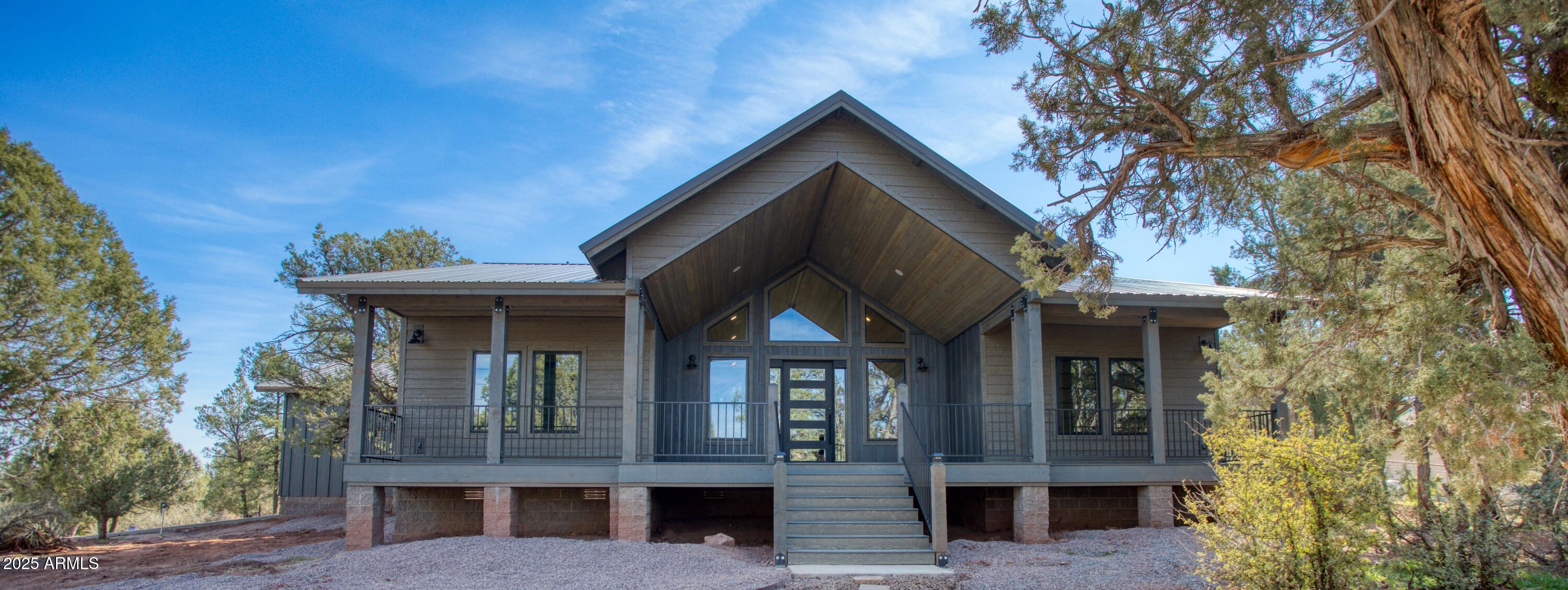 957 Cheney Ranch Loop Show Low, AZ 85901 - Photo 20 of 32 a view of house with a tree and wooden fence