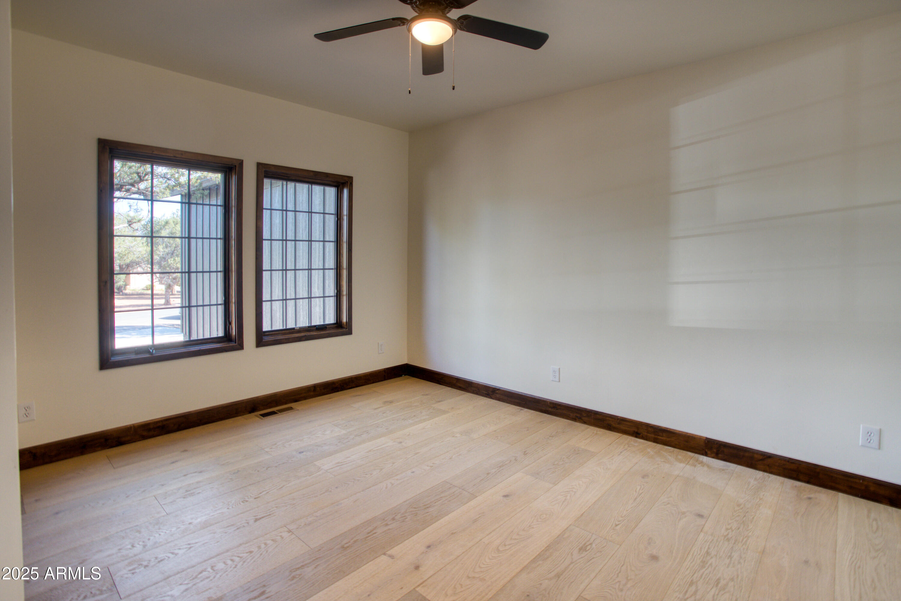 957 Cheney Ranch Loop Show Low, AZ 85901 - Photo 24 of 32 an empty room with chandelier fan