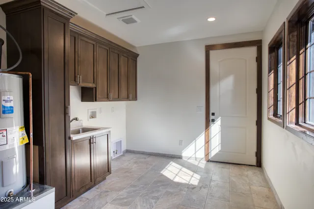 a view of a refrigerator in kitchen and an empty room