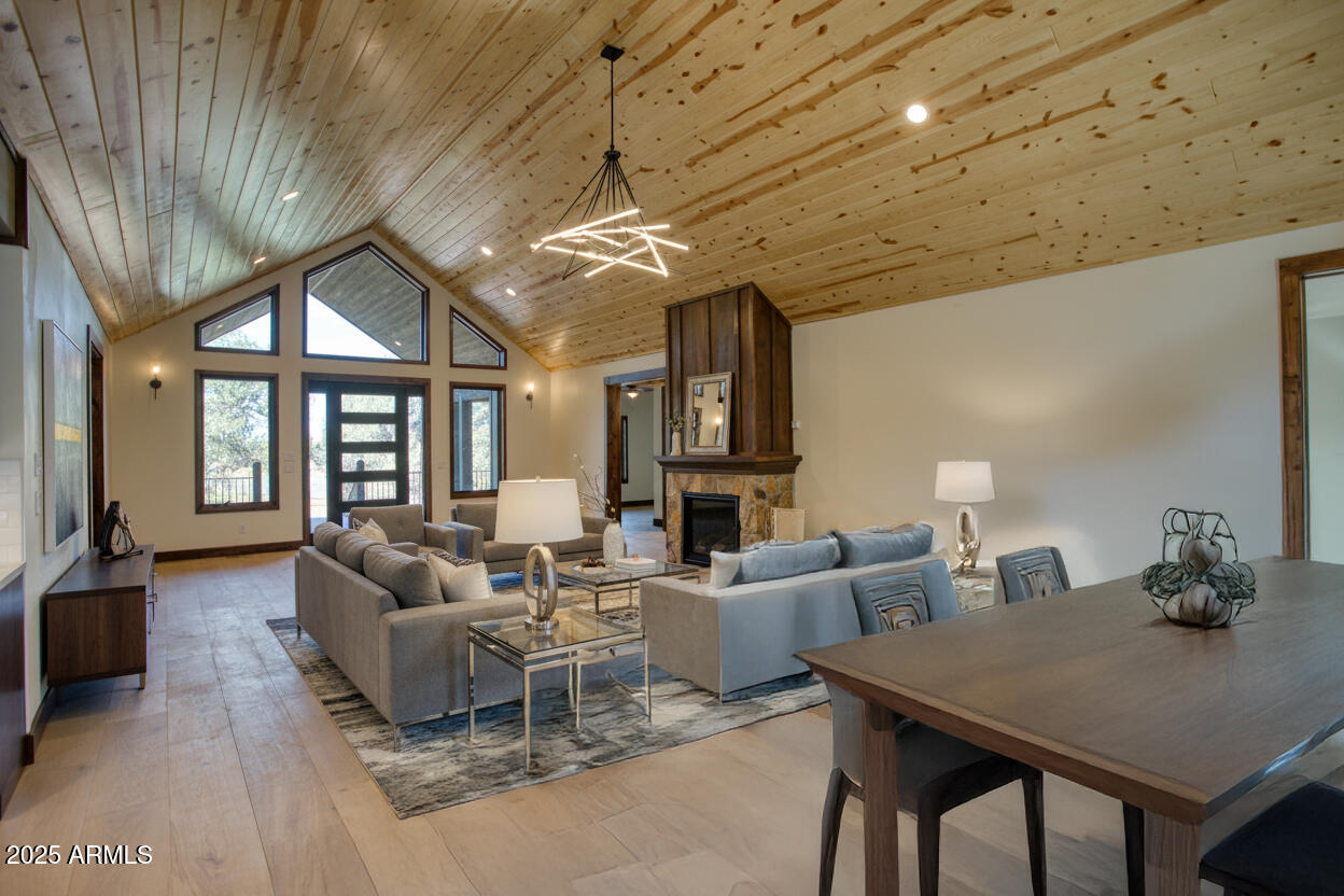 957 Cheney Ranch Loop Show Low, AZ 85901 - Photo 3 of 32 a living room with furniture a chandelier and a flat screen tv