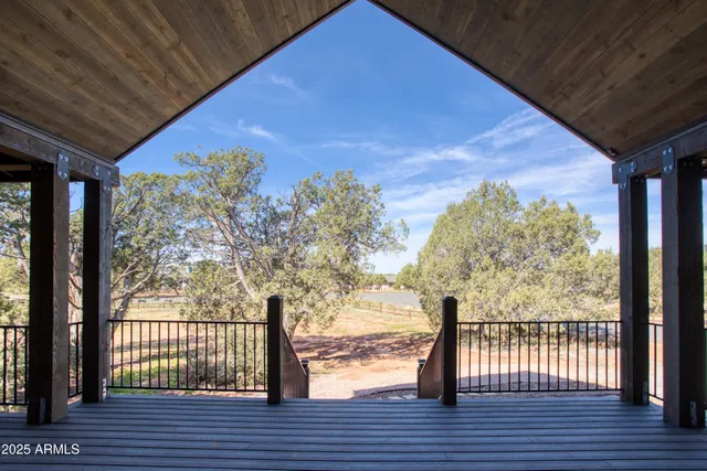a view of balcony with wooden floor and fence