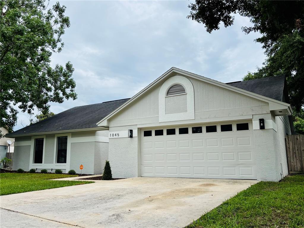 1045 Shaffer Trail Oviedo, FL 32765 - Photo 2 of 30 a front view of a house with a yard