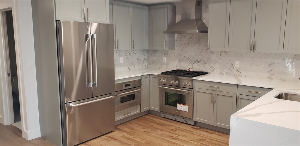 50 Hichborn Street, Unit 311 Boston, MA 02135 - Photo 14 of 19 a kitchen with appliances and cabinets