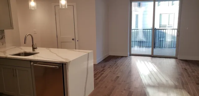 a kitchen with a sink and wooden floor