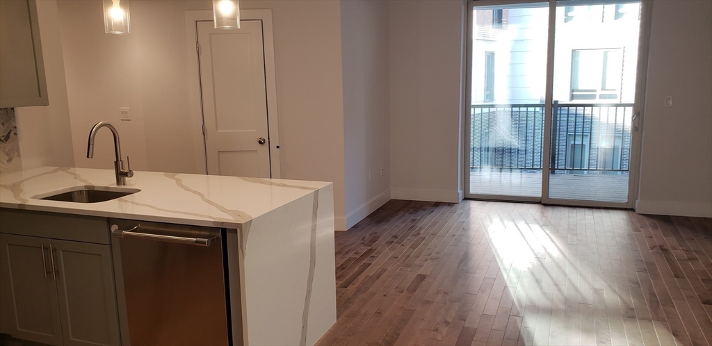 50 Hichborn Street, Unit 311 Boston, MA 02135 - Photo 8 of 19 a kitchen with a sink and wooden floor