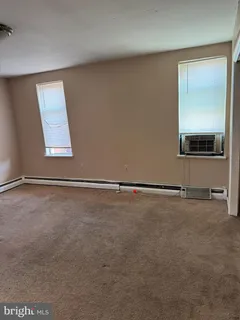 an empty room with a empty space and windows