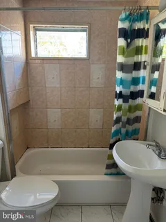 a bathroom with a sink a toilet and bathtub