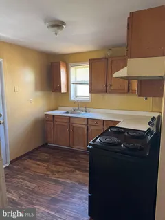 a kitchen with a sink a stove and cabinets