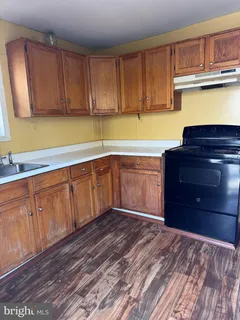 a kitchen with wooden cabinets and a sink