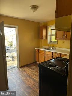 a kitchen that has a sink stainless steel appliances a counter space and a window