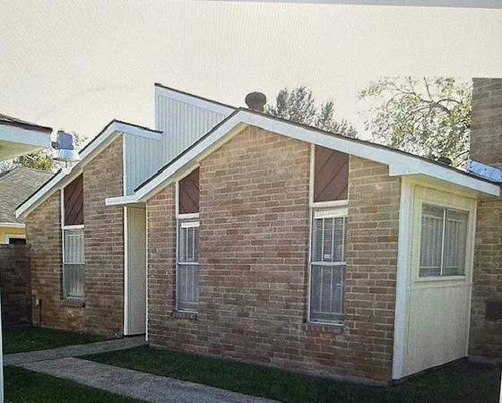 a view of a brick house with brick walls