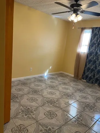 a view of a big room with closet and a chandelier fan