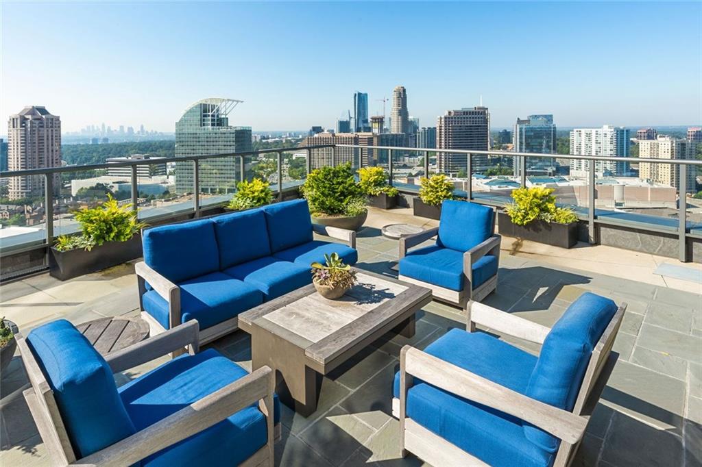 3630 Peachtree Road Northeast, Unit 2104 Atlanta, GA 30326 - Photo 16 of 98 a roof deck with patio couch and a potted plant