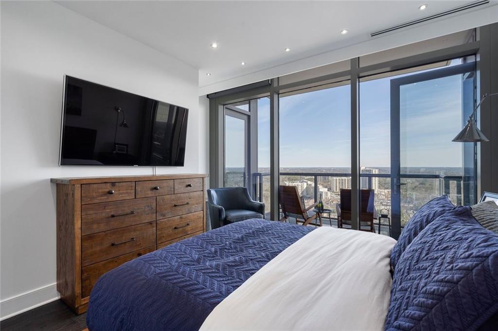 3630 Peachtree Road Northeast, Unit 2104 Atlanta, GA 30326 - Photo 54 of 98 a bedroom with a bed and a flat screen tv