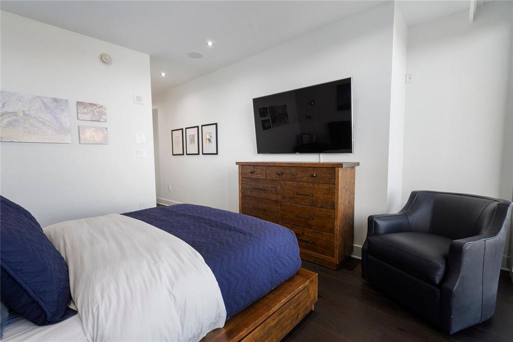 3630 Peachtree Road Northeast, Unit 2104 Atlanta, GA 30326 - Photo 56 of 98 a bedroom with a bed and a television