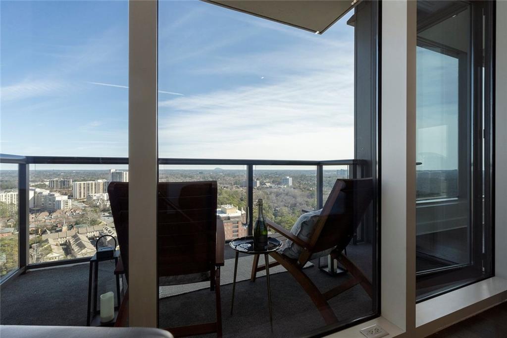 3630 Peachtree Road Northeast, Unit 2104 Atlanta, GA 30326 - Photo 57 of 98 a view of a balcony with chairs and front door