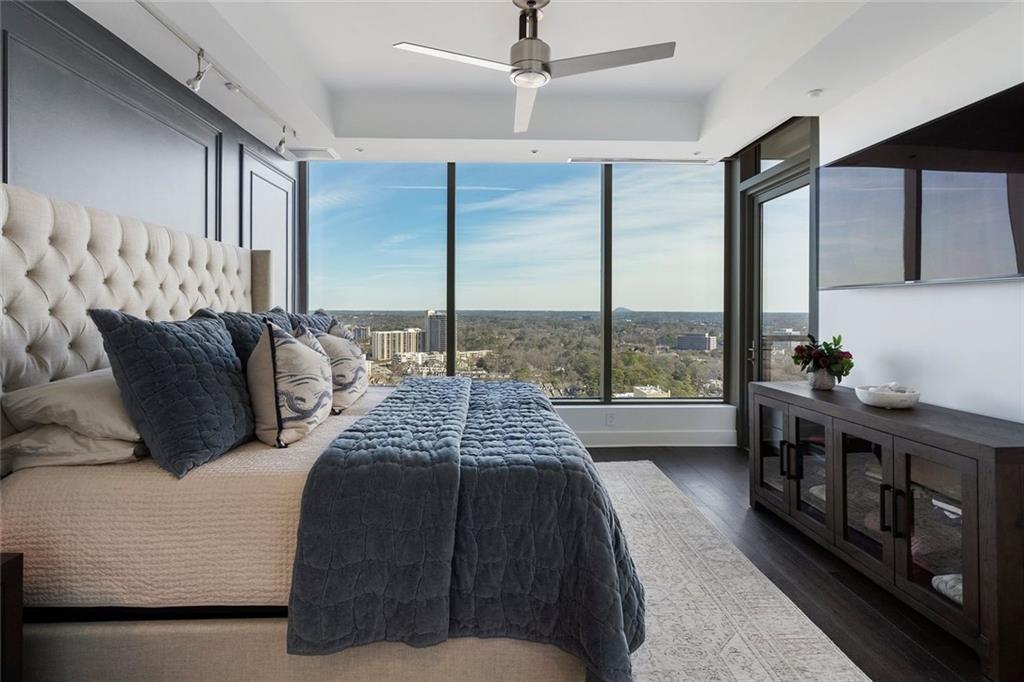 3630 Peachtree Road Northeast, Unit 2104 Atlanta, GA 30326 - Photo 60 of 98 a bedroom with a bed next to a large window with the outer view
