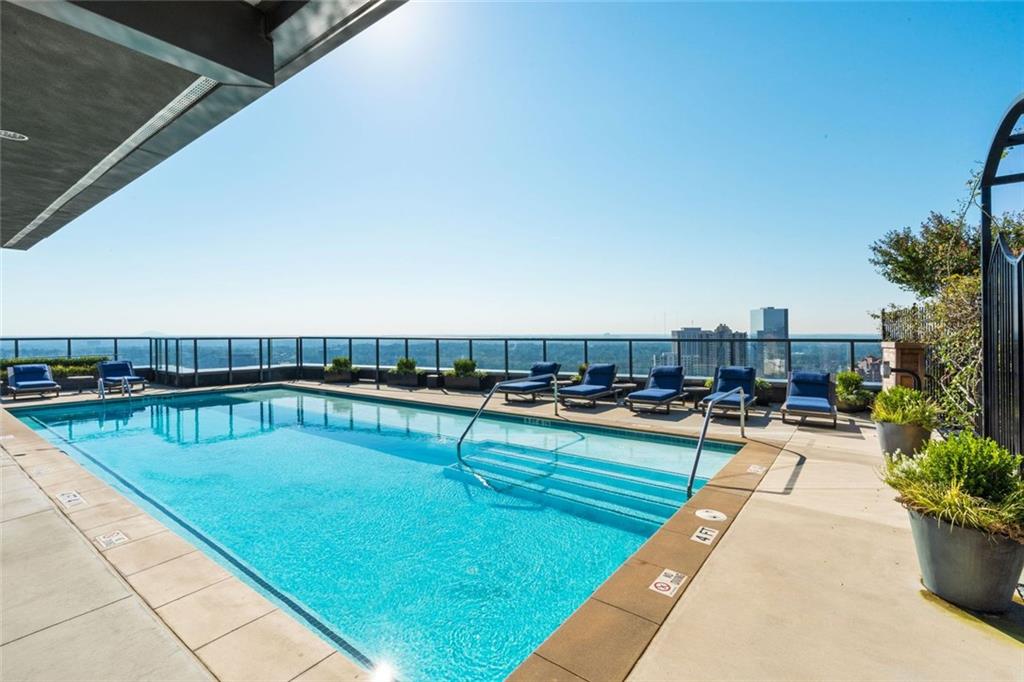 3630 Peachtree Road Northeast, Unit 2104 Atlanta, GA 30326 - Photo 6 of 98 a view of a swimming pool with a lounge chairs