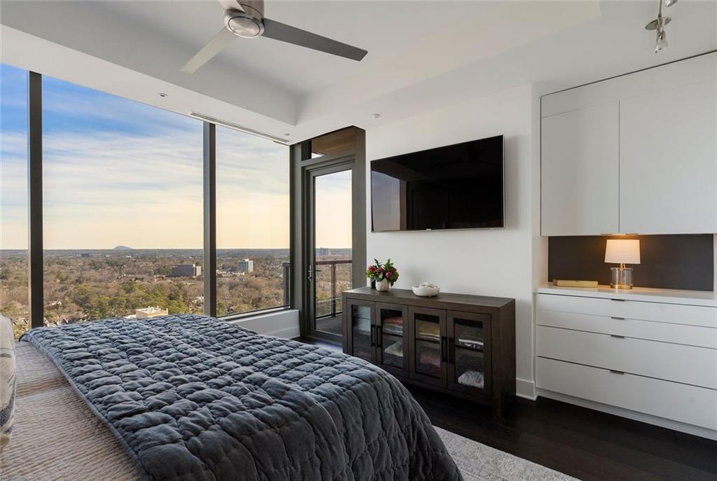 3630 Peachtree Road Northeast, Unit 2104 Atlanta, GA 30326 - Photo 61 of 98 a bedroom with a large bed and a flat screen tv