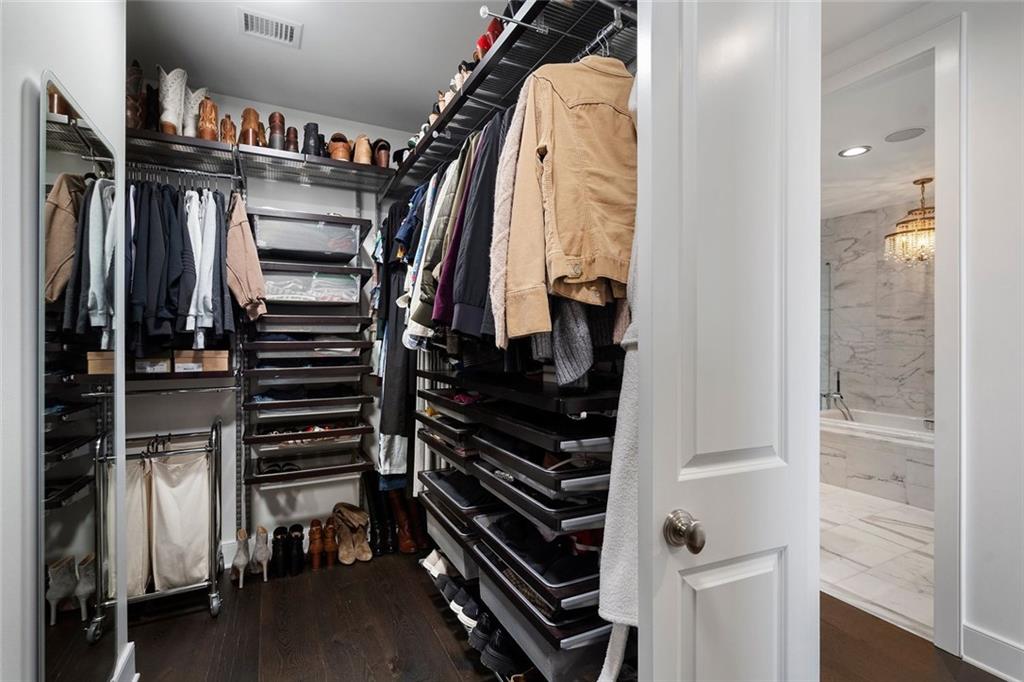 3630 Peachtree Road Northeast, Unit 2104 Atlanta, GA 30326 - Photo 65 of 98 a view of walk in closet with clothes and shoes