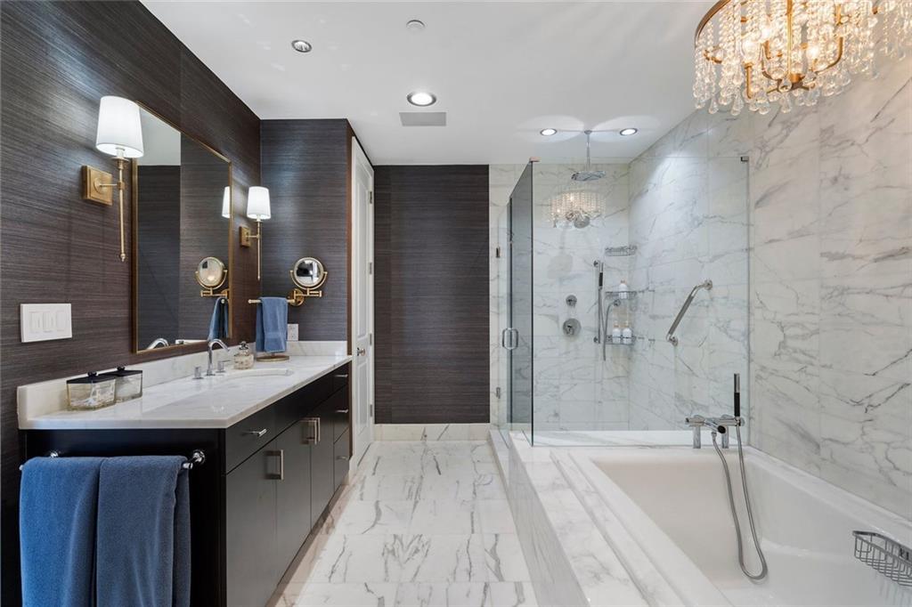 3630 Peachtree Road Northeast, Unit 2104 Atlanta, GA 30326 - Photo 67 of 98 a spacious bathroom with a bathtub shower sink and mirror
