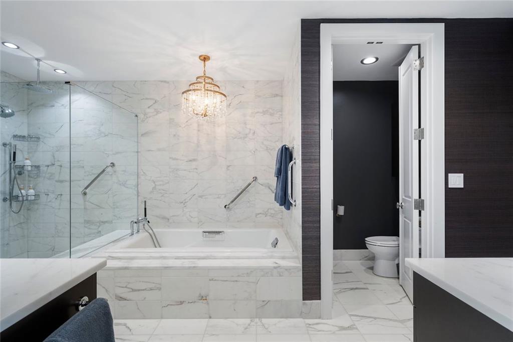 3630 Peachtree Road Northeast, Unit 2104 Atlanta, GA 30326 - Photo 69 of 98 a bathroom with a bathtub and a shower