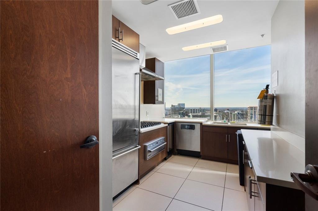3630 Peachtree Road Northeast, Unit 2104 Atlanta, GA 30326 - Photo 83 of 98 a kitchen with stainless steel appliances granite countertop a refrigerator sink and stove