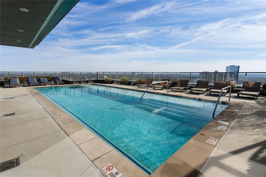 3630 Peachtree Road Northeast, Unit 2104 Atlanta, GA 30326 - Photo 88 of 98 a view of a swimming pool with lawn chairs