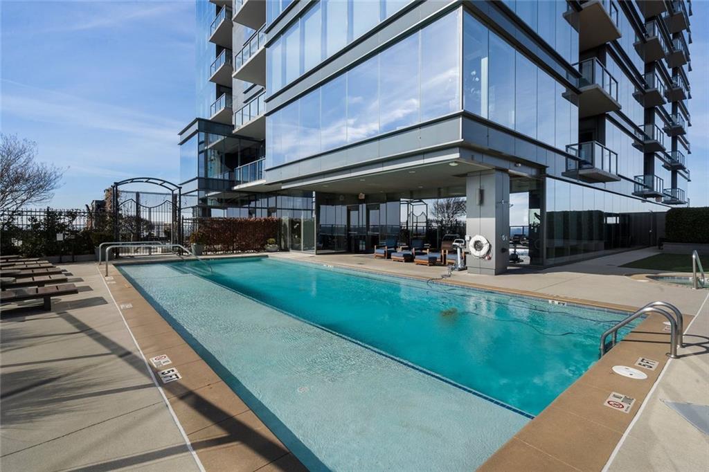 3630 Peachtree Road Northeast, Unit 2104 Atlanta, GA 30326 - Photo 90 of 98 a view of a building and a yard with a patio