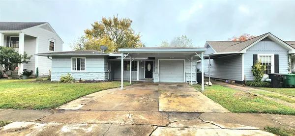 a front view of a house with a garden and patio