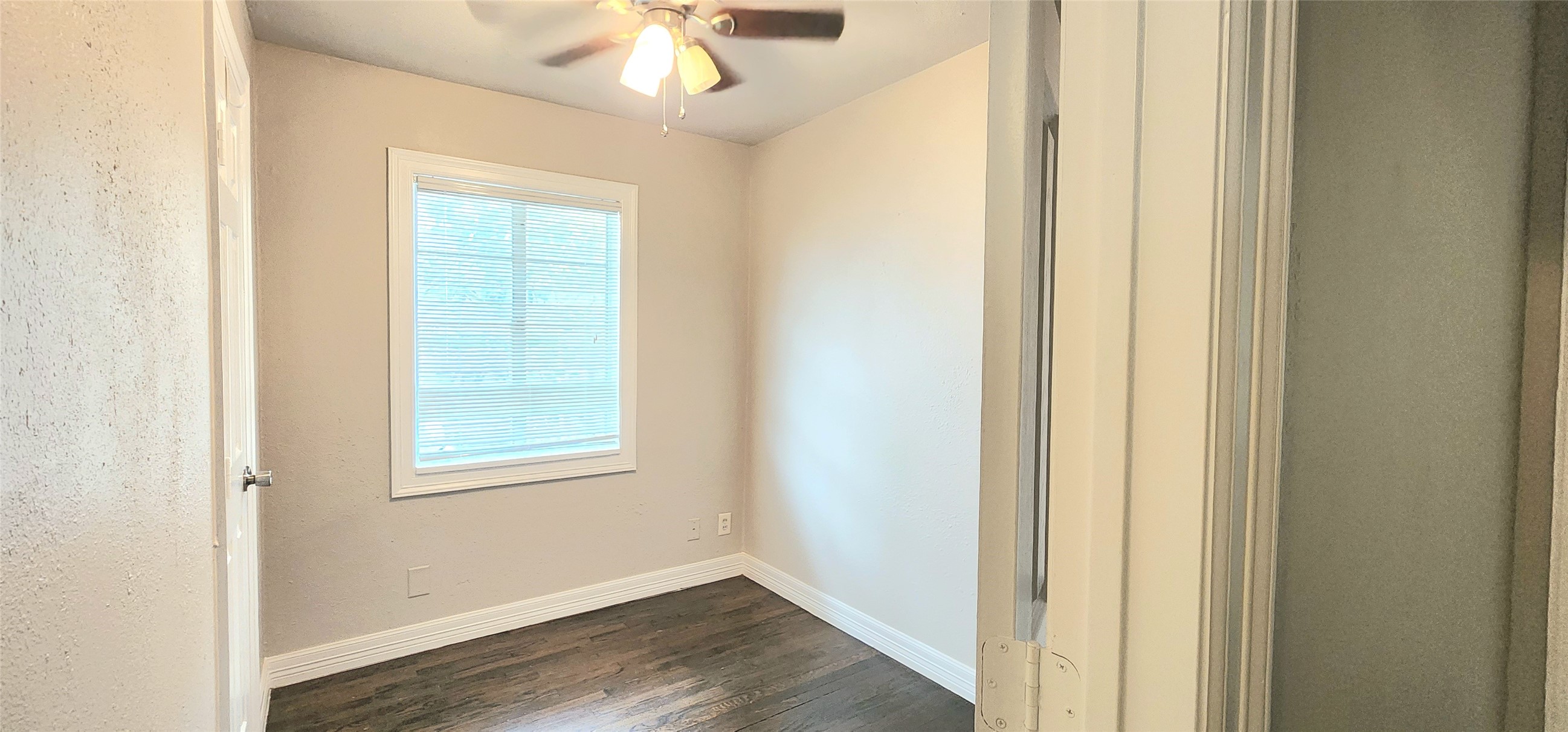 6927 Burgess Street Houston, TX 77021 - Photo 13 of 22 an empty room with wooden floor cabinet and windows
