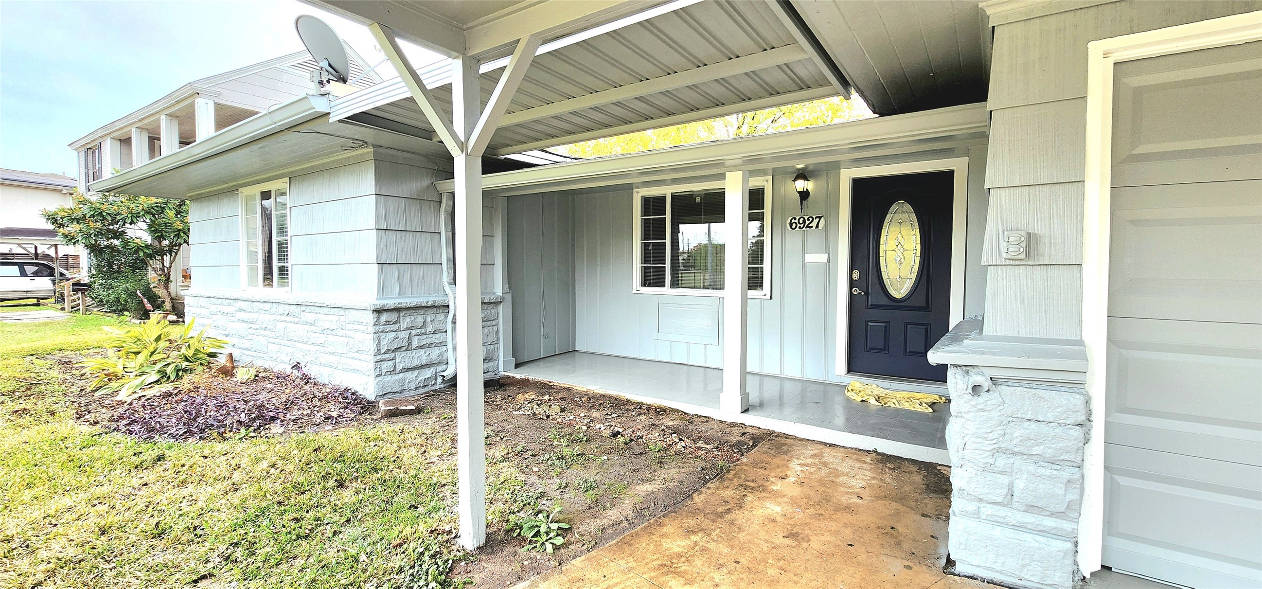 6927 Burgess Street Houston, TX 77021 - Photo 2 of 22 a view of a porch with a bench and floor to ceiling window