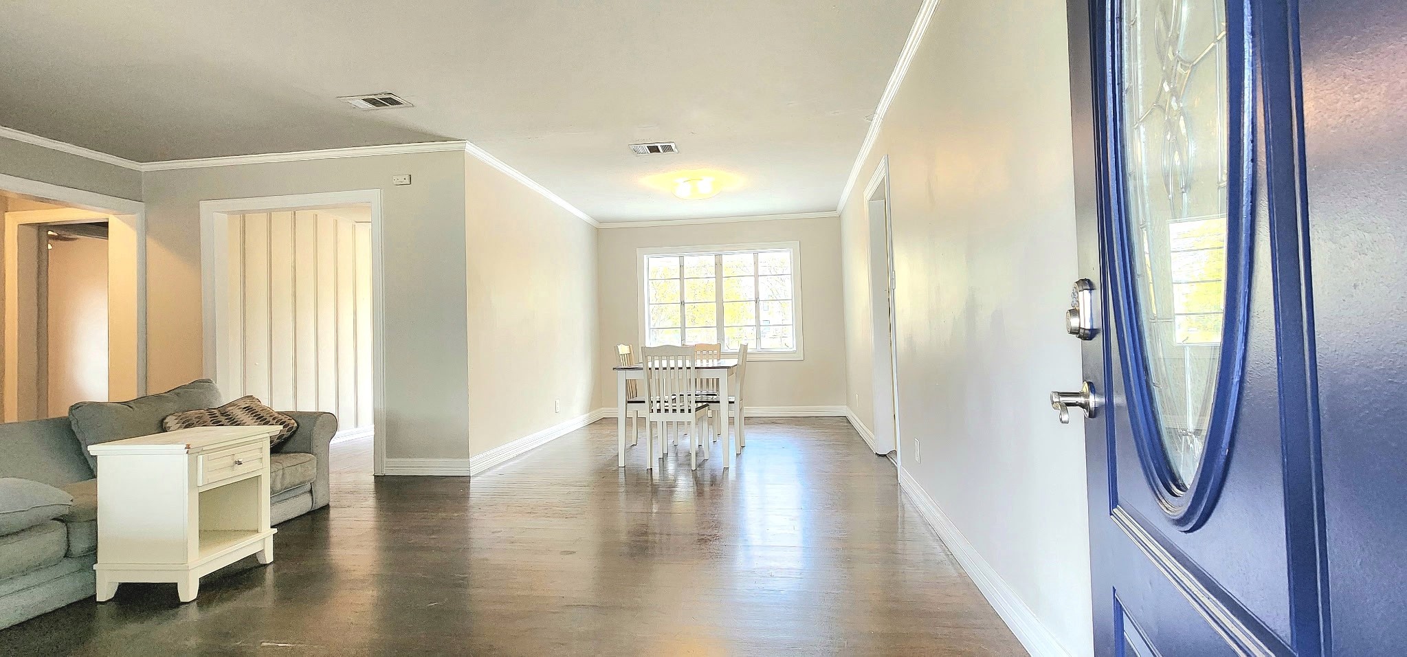 6927 Burgess Street Houston, TX 77021 - Photo 3 of 22 a hallway with wooden floor and furniture