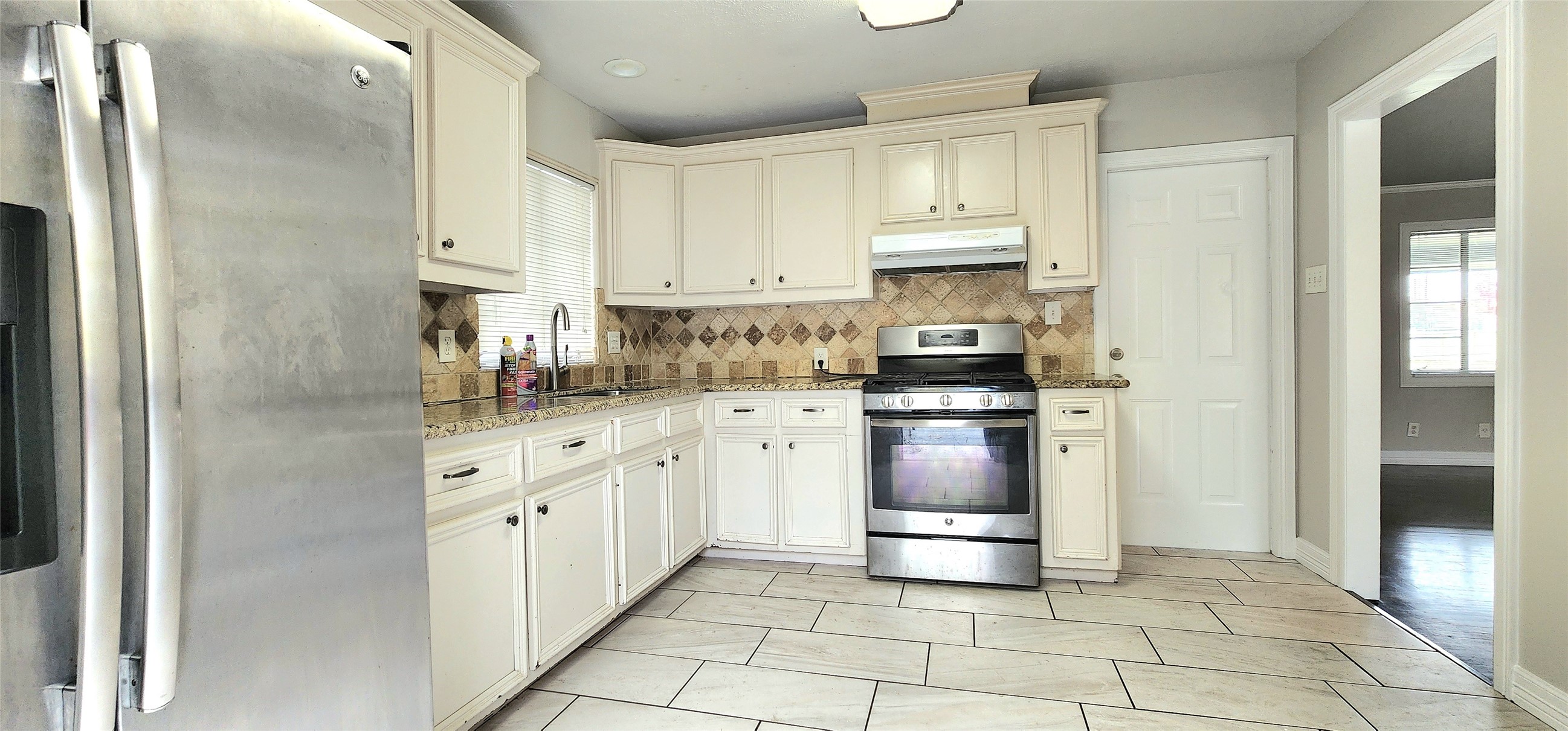 6927 Burgess Street Houston, TX 77021 - Photo 9 of 22 a kitchen with stainless steel appliances granite countertop a refrigerator and a stove