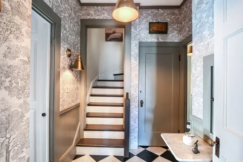 a view of entryway and hall with wooden floor