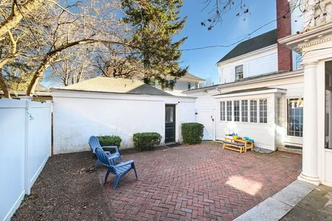 a building outdoor space with patio furniture and potted plants