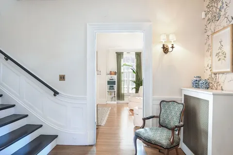 a hallway with furniture and wooden floor