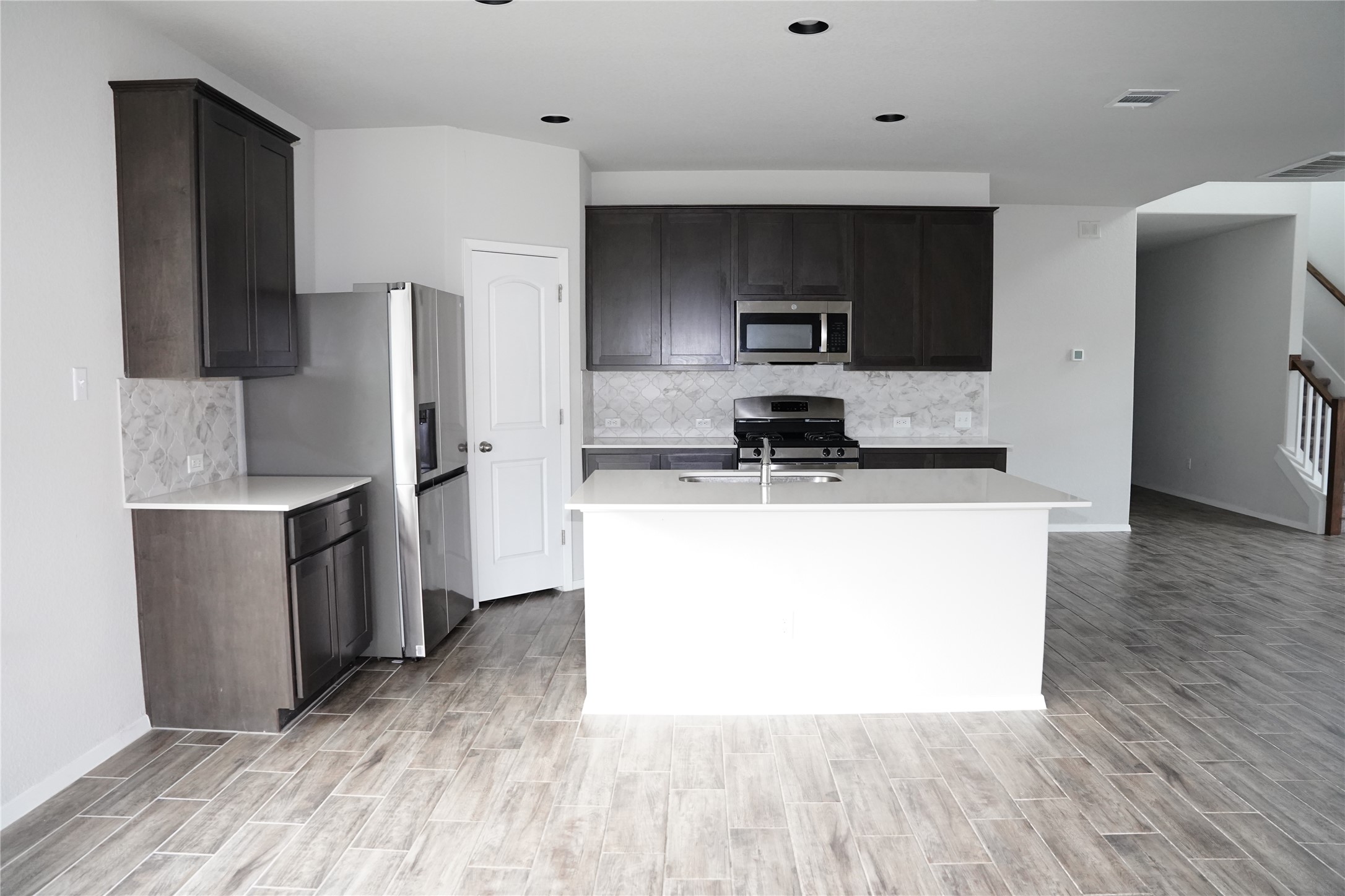 117 Crescent Street Georgetown, TX 78626 - Photo 9 of 38 A well-appointed kitchen showcasing an island and durable tile flooring, perfect for modern living.