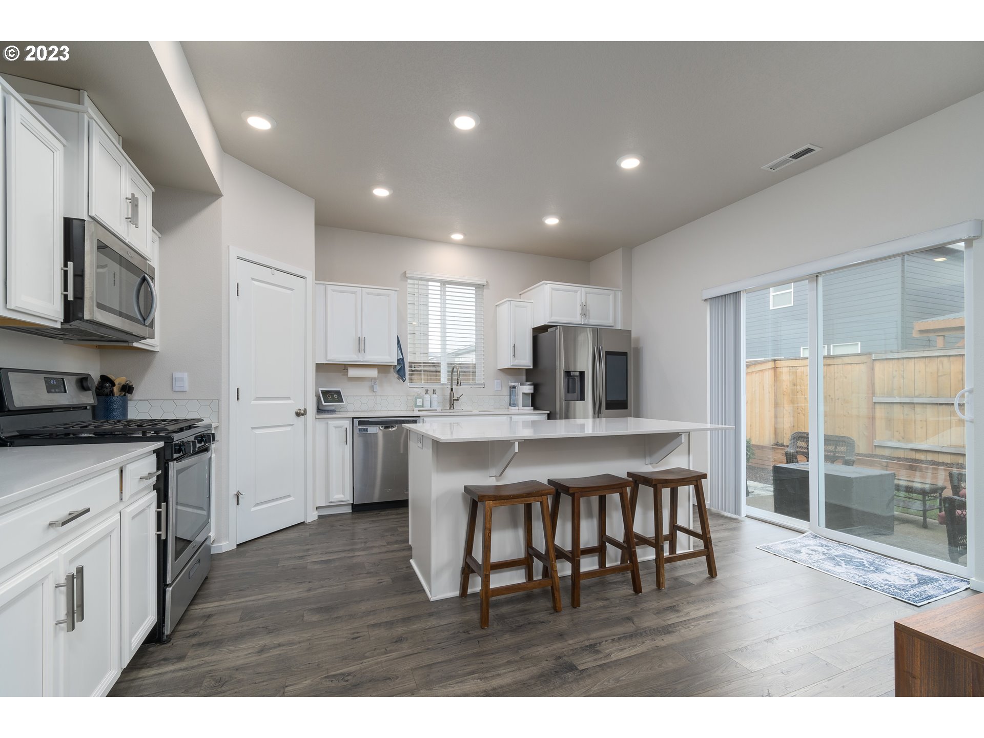 2914 Fenya Street Springfield, OR 97477 - Photo 12 of 35 a kitchen with kitchen island granite countertop a sink cabinets and stainless steel appliances