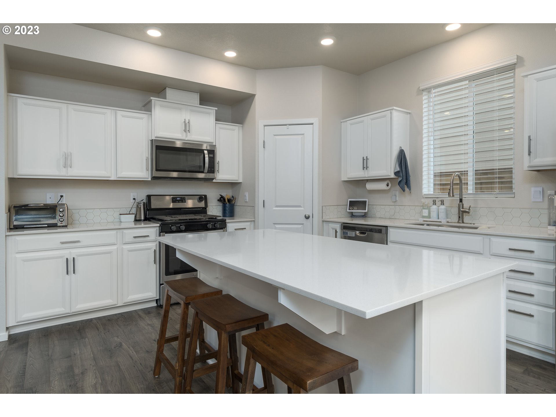 2914 Fenya Street Springfield, OR 97477 - Photo 14 of 35 a kitchen with kitchen island a sink counter top space cabinets and stainless steel appliances