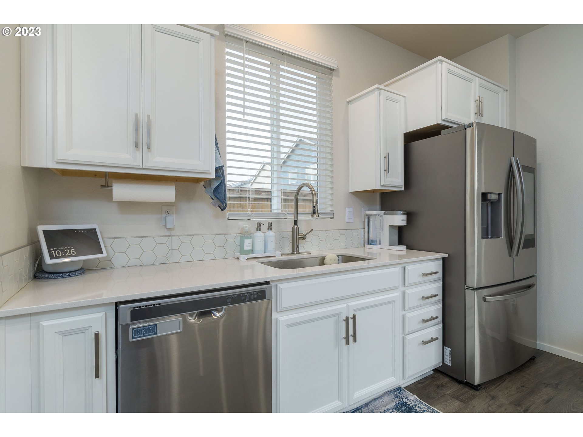 2914 Fenya Street Springfield, OR 97477 - Photo 15 of 35 a kitchen with a sink a refrigerator a window and cabinets