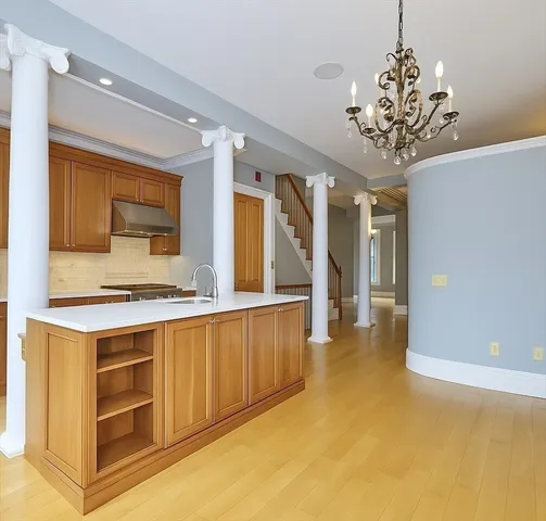 a spacious bedroom with a bed and a chandelier