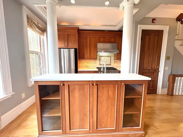 a kitchen with stainless steel appliances granite countertop a stove a sink and a microwave