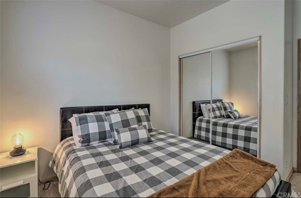 26388 Thunderbird Drive Lake Arrowhead, CA 92352 - Photo 14 of 27 a bedroom with a bed and wooden floor