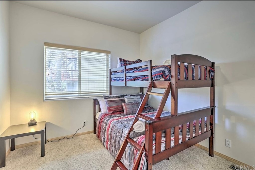 26388 Thunderbird Drive Lake Arrowhead, CA 92352 - Photo 19 of 27 a bedroom with furniture and a window