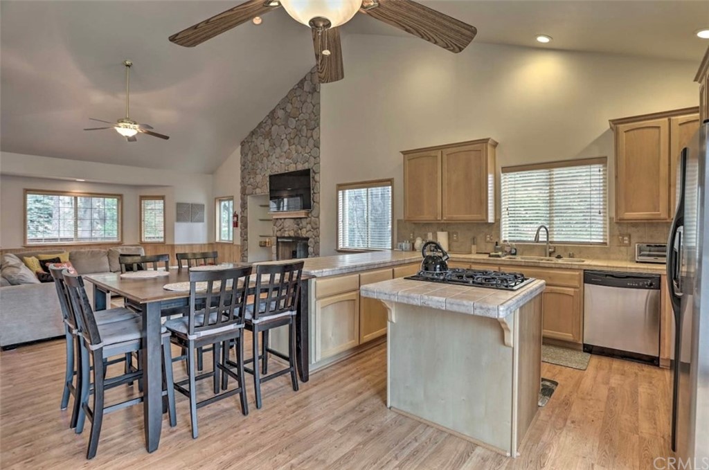 26388 Thunderbird Drive Lake Arrowhead, CA 92352 - Photo 10 of 27 a kitchen with kitchen island granite countertop wooden floors and stainless steel appliances